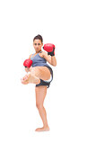 Stern sporty brunette kick boxing