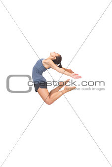 Flexible sporty brunette jumping in the air