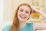 Laughing redhead sitting on the couch