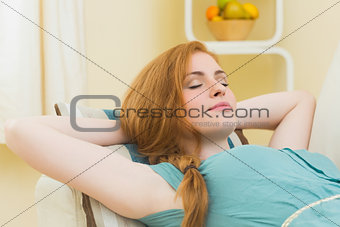 Peaceful redhead lying on the couch asleep
