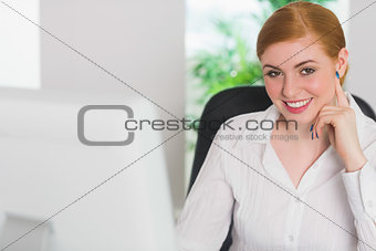 Happy businesswoman working at her desk