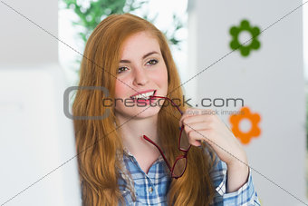 Beautiful redhead sitting at her desk and smiling