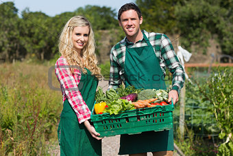 Happy couple showing vegetables