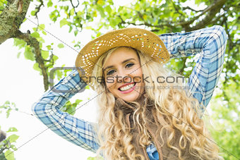 Beautiful blonde woman wearing a straw hat