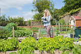 Blonde woman standing in her garden