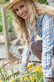 Smiling young woman working in the garden