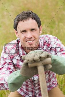 Smiling man posing with a shovel