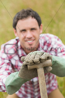 Handsome young man posing with a shovel