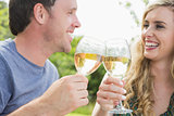 Cheerful couple toasting with white wine