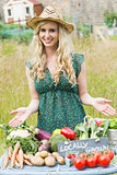 Blonde woman presenting her vegetables to sell