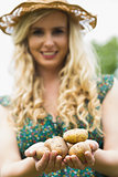 Young woman holding some potatoes