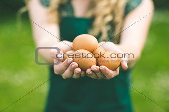 Young woman showing eggs