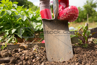 Woman wearing rubber boots working in the garden
