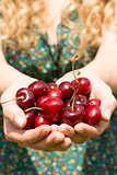 Close up of a blonde woman showing some cherries