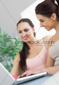 Two young women working with their notebook
