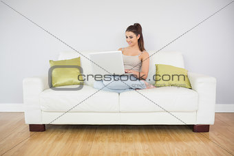 Happy woman using her notebook