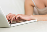 Young woman typing on her laptop