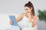 Beautiful young woman looking at digital tablet