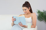 Interested young woman reading a book
