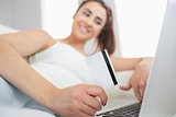 Young woman using her notebook for online shopping