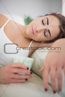 Tired young woman sleeping on a couch