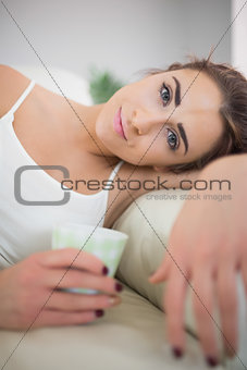 Beautiful smiling woman lying on a couch