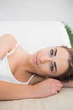 Cute smiling woman lying on a couch