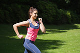 Fit woman running in the sunshine