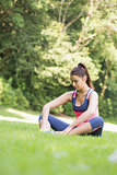 Young fit woman sitting on the ground