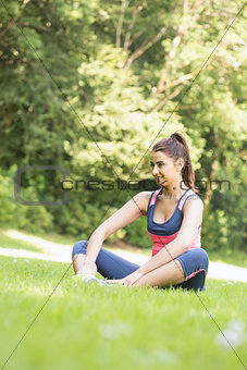 Beautiful fit woman sitting on the ground