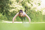 Fit young woman doing plank position
