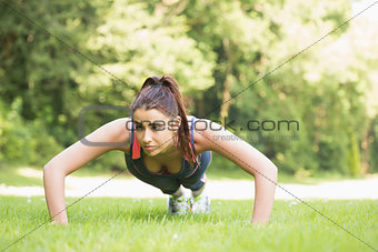 Serious fit woman doing plank position
