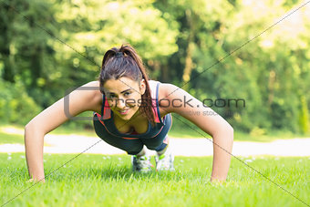 Smiling fit woman doing plank position