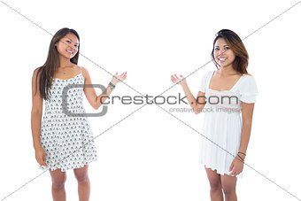 Two pretty asian women presenting