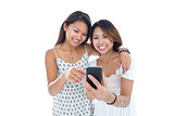 Smiling young women using a smartphone