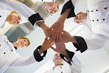 Chefs joining hands in a circle