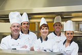 Five chefs posing with crossed arms