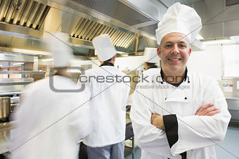 Head chef posing proudly in kitchen