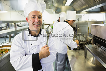 Experienced male chef posing in a kitchen
