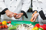 Close up of two chefs preparing vegetables