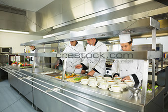 Four chefs working in a big kitchen