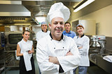 Head chef posing with team behind him