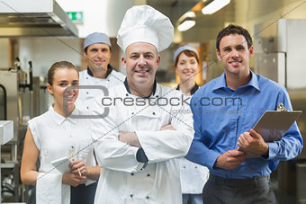 Head chef posing with the team behind him