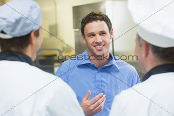 Young smiling manager talking to the staff