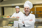 Mature chef posing proudly in a professional kitchen