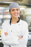 Young female chef posing with crossed arms