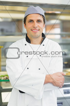Young male chef posing with crossed arms