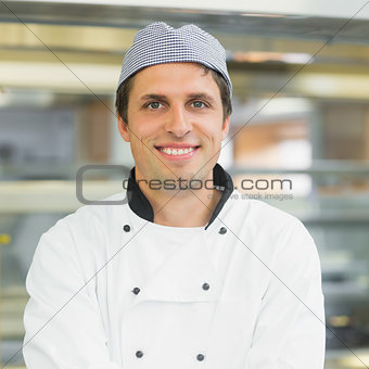 Handsome young chef smiling at camera