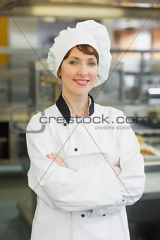 Pretty female chef posing in a modern kitchen