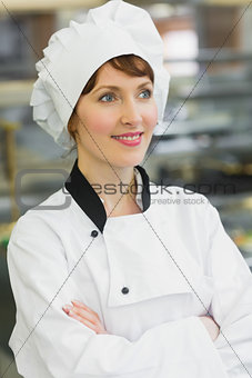 Smiling female chef posing in a kitchen